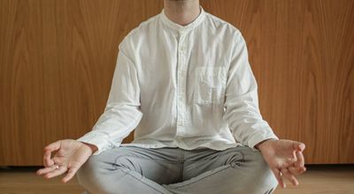 Person calmly practicing yoga, emphasizing stress relief.