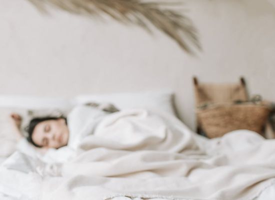 Person sleeping peacefully in a comfortable bed.