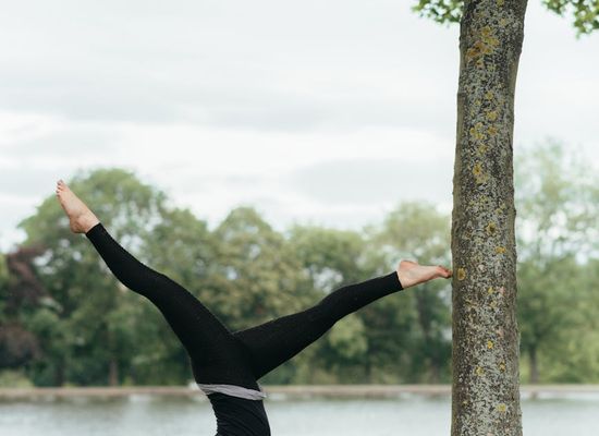 Woman performing a gentle yoga stretch to improve flexibility.